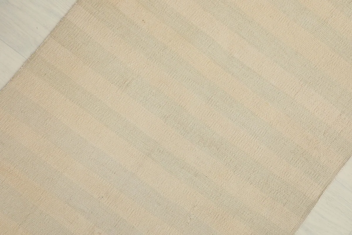 Diagonal view highlighting the subtle horizontal color variations across the rug's surface.