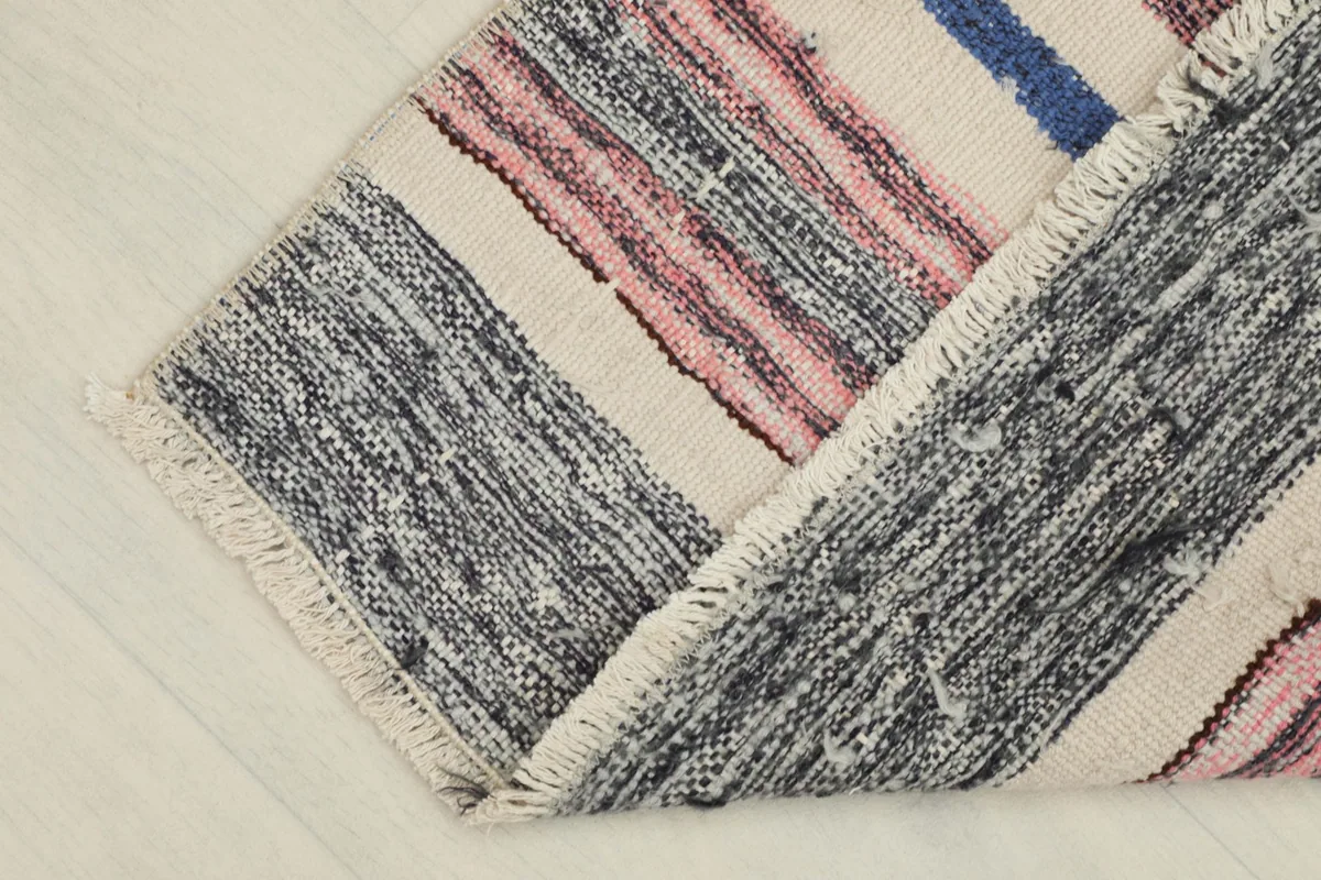 The rug partially folded, showing the thickness and the back of the rug along a fold.