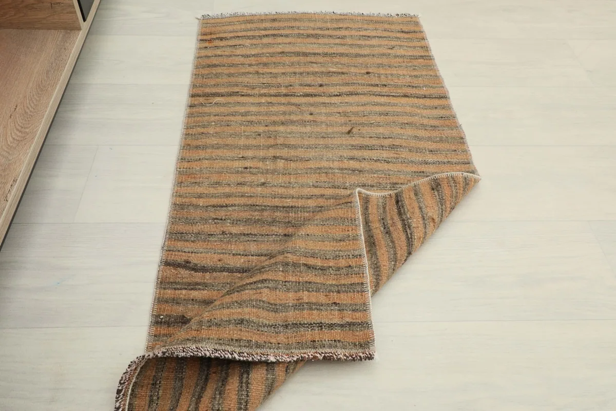 View of the rug partially folded, showcasing its flexibility and construction.