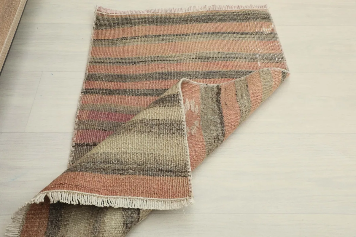 The doormat partially folded, showing the flexibility and construction from a different angle.