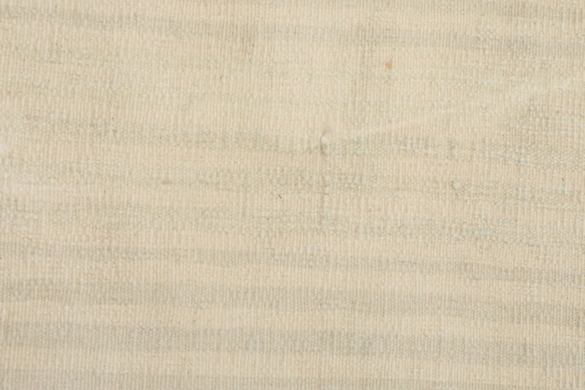 Detailed shot of the rug's surface, revealing the subtle horizontal stripe pattern and wool texture.
