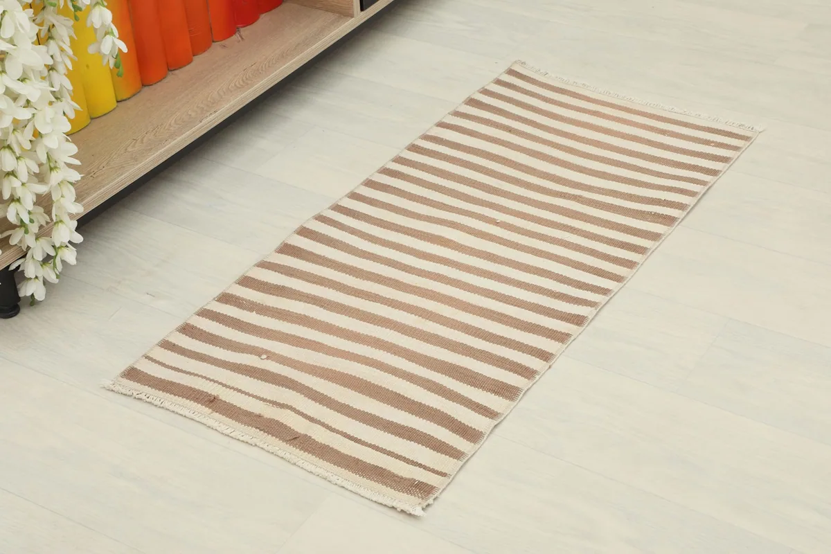 Angled view of the striped Anatolian doormat, showing its full length