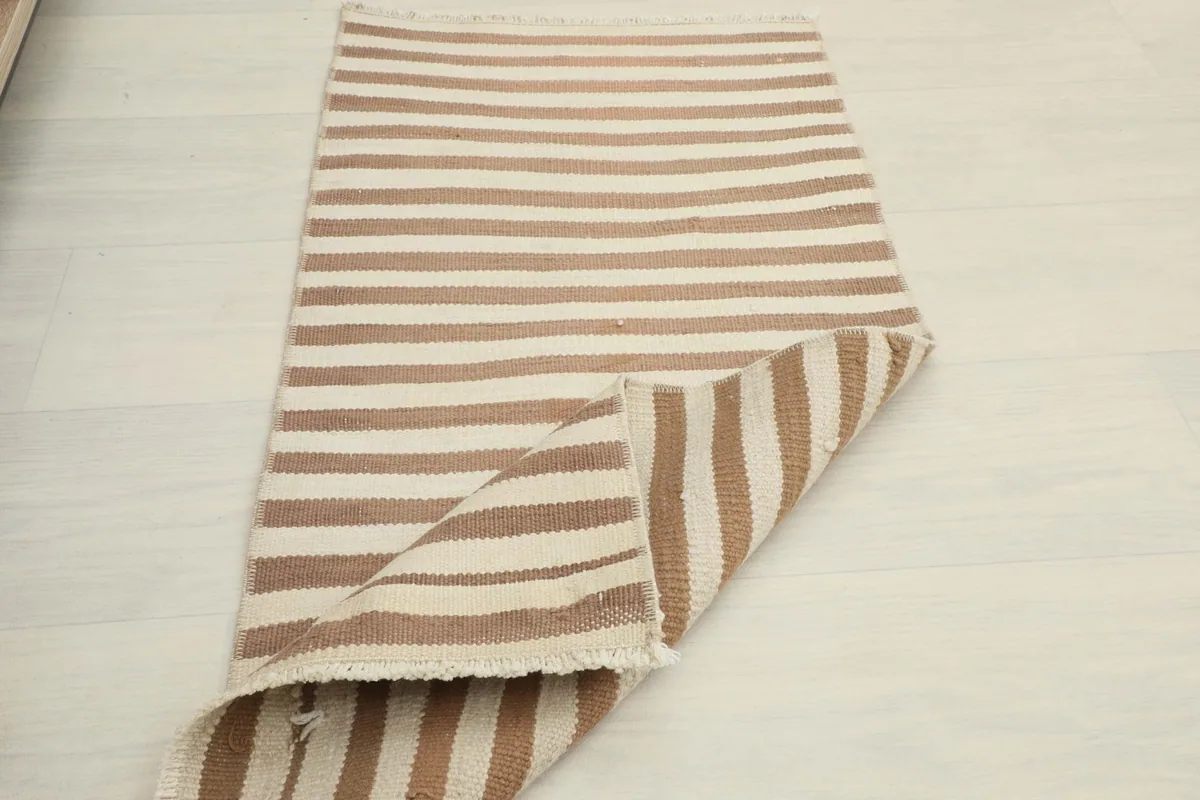 Partially folded rug on a white floor, showing flexibility