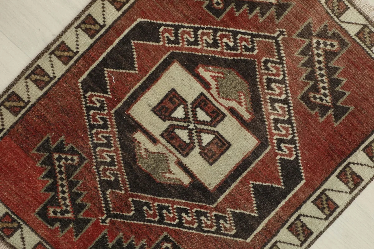 Overhead close-up showing the central geometric medallion and surrounding tribal patterns