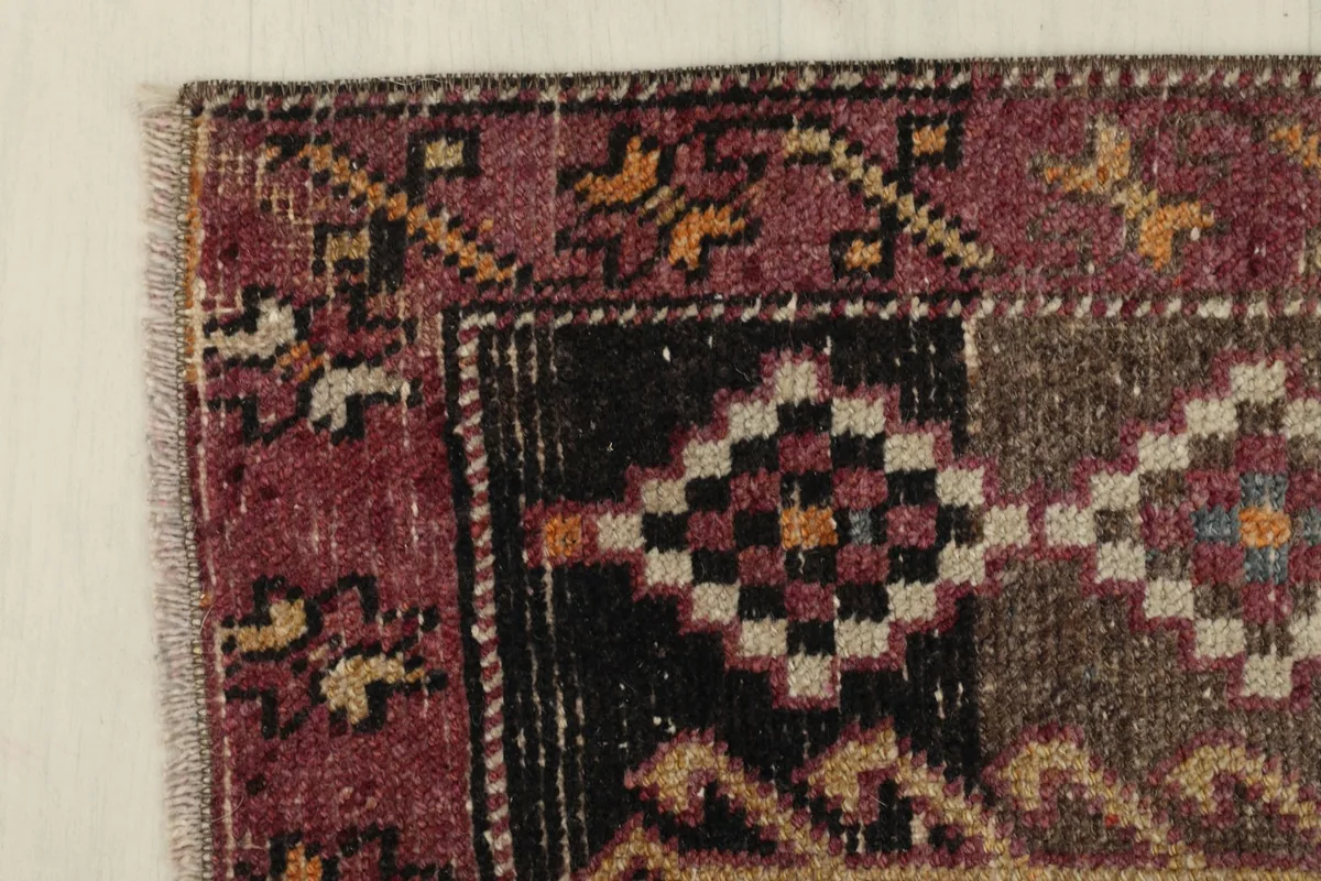 Close-up of the intricate patterns and colors in a corner of the rug