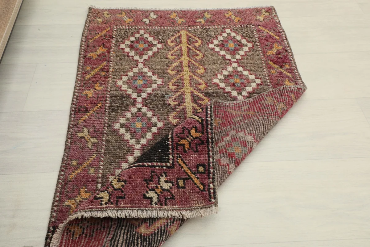 The rug partially folded, revealing its thickness and construction