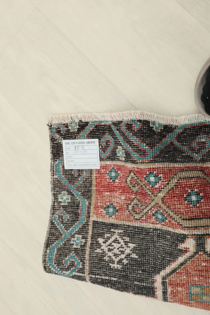 View of the rug's back, showing the cotton foundation and the reverse of the hand-knotted construction.