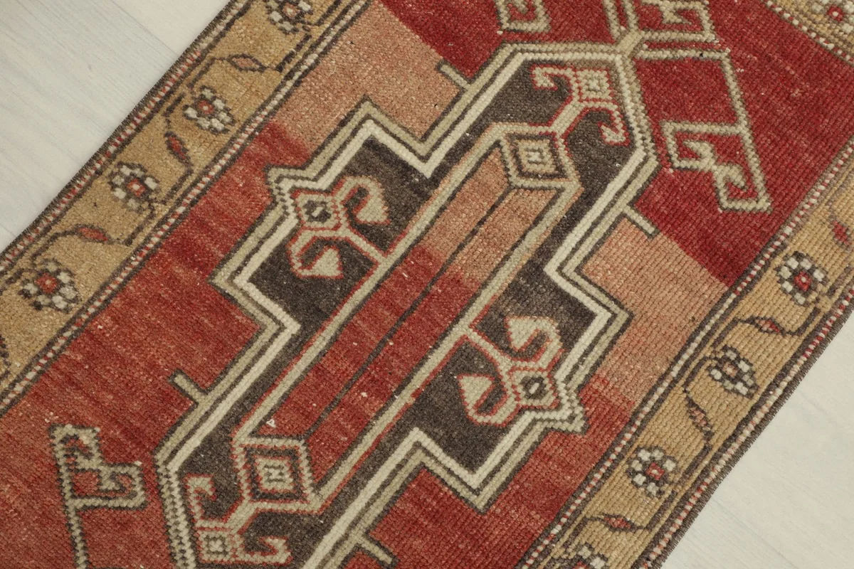 Diagonal close-up showing the central geometric pattern in rust, tan, and brown