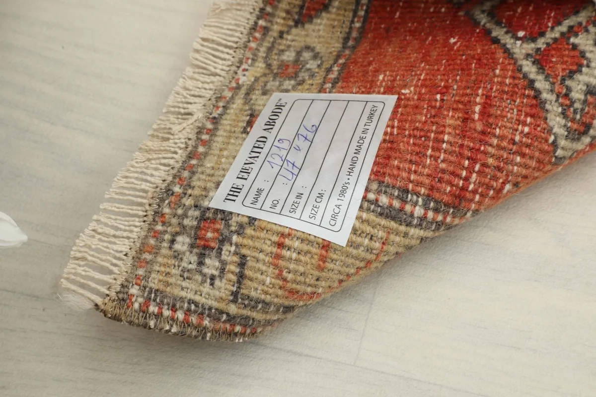 Back of the rug showing the hand-knotted weave and product label