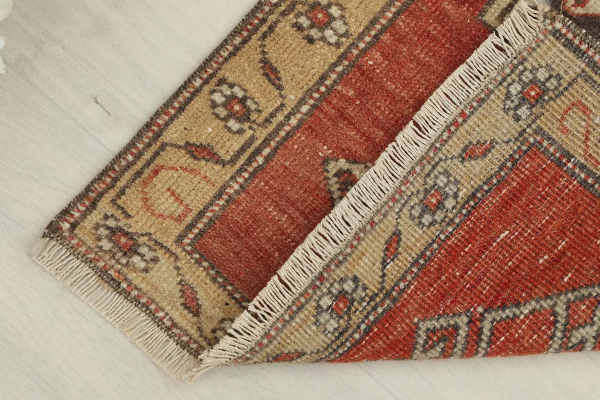 Rug corner folded to show thickness and back of the hand-knotted construction
