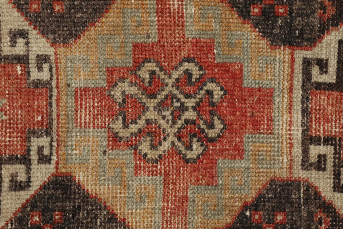 Detailed view of the low wool pile and the intricate hand-knotted weave, highlighting color variations.