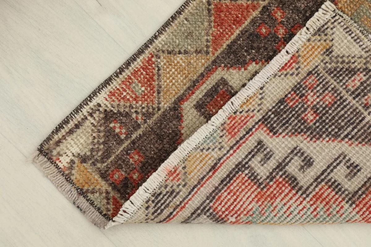 The rug folded to reveal the thickness of the wool pile and the cotton foundation.