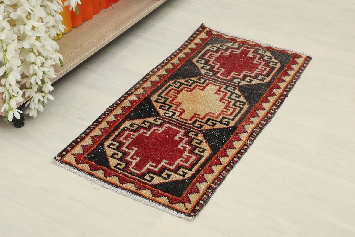 Angled view of the hand-knotted wool rug, showing its colors and pattern
