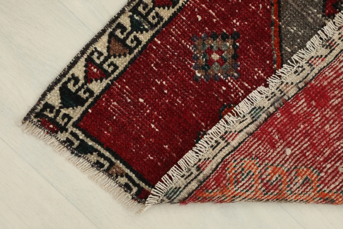 View of the rug's back, revealing the hand-knotted cotton foundation and wool pile.