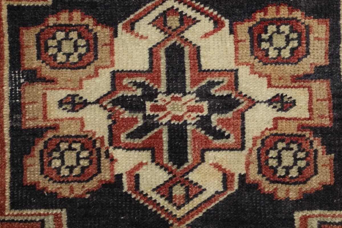 Detailed view of the intricate patterns within the central medallion of the vintage Anatolian rug.