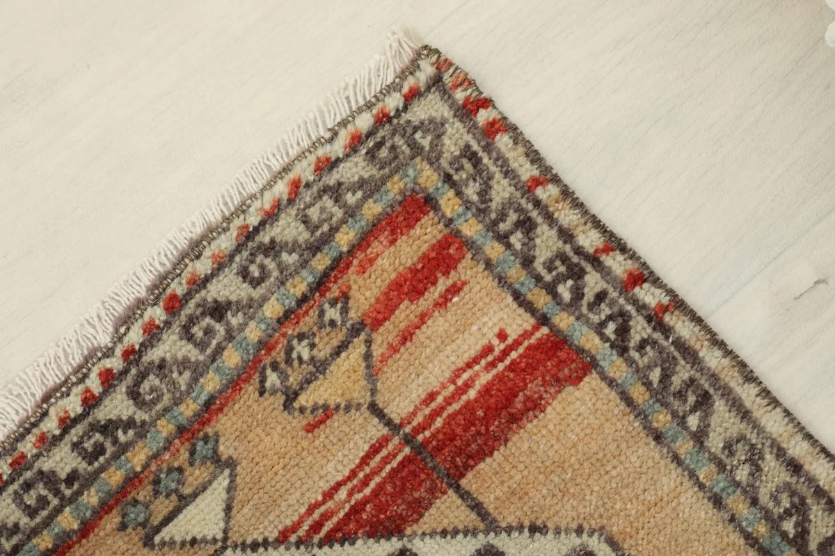 Overhead corner view of the rug, detailing the hand-knotted texture and fringe