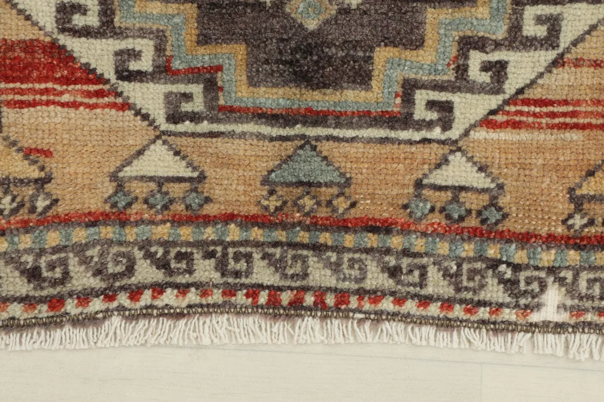 Close-up of one end of the rug, highlighting the border design and fringe
