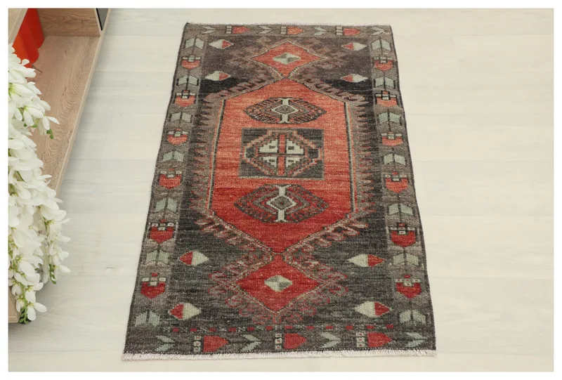 Full top view of the vintage Anatolian rug with charcoal and red geometric patterns