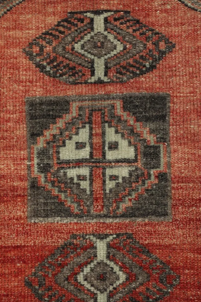 Close-up of the main geometric motifs in red, charcoal, and beige