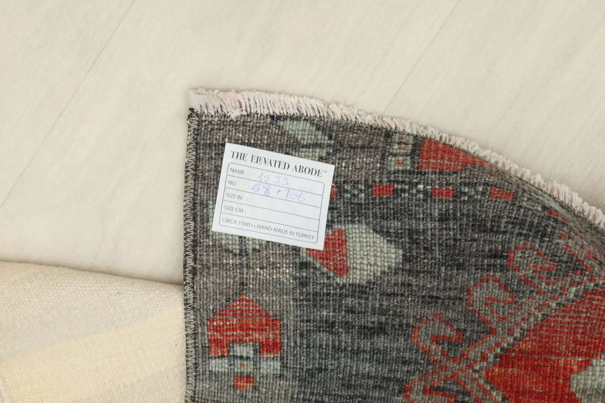 Back of the rug with a label, showing the hand-knotted construction