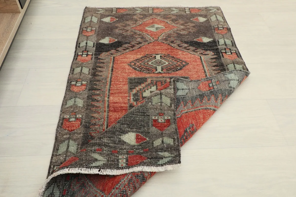 Rug partially folded, showcasing the full design and vintage texture