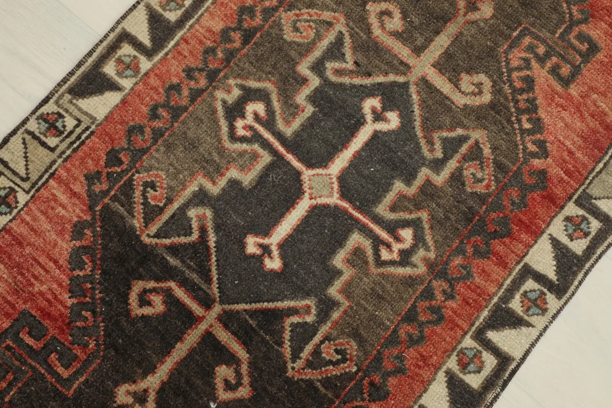 Overhead close-up of the intricate black and gray geometric design within the rug's center