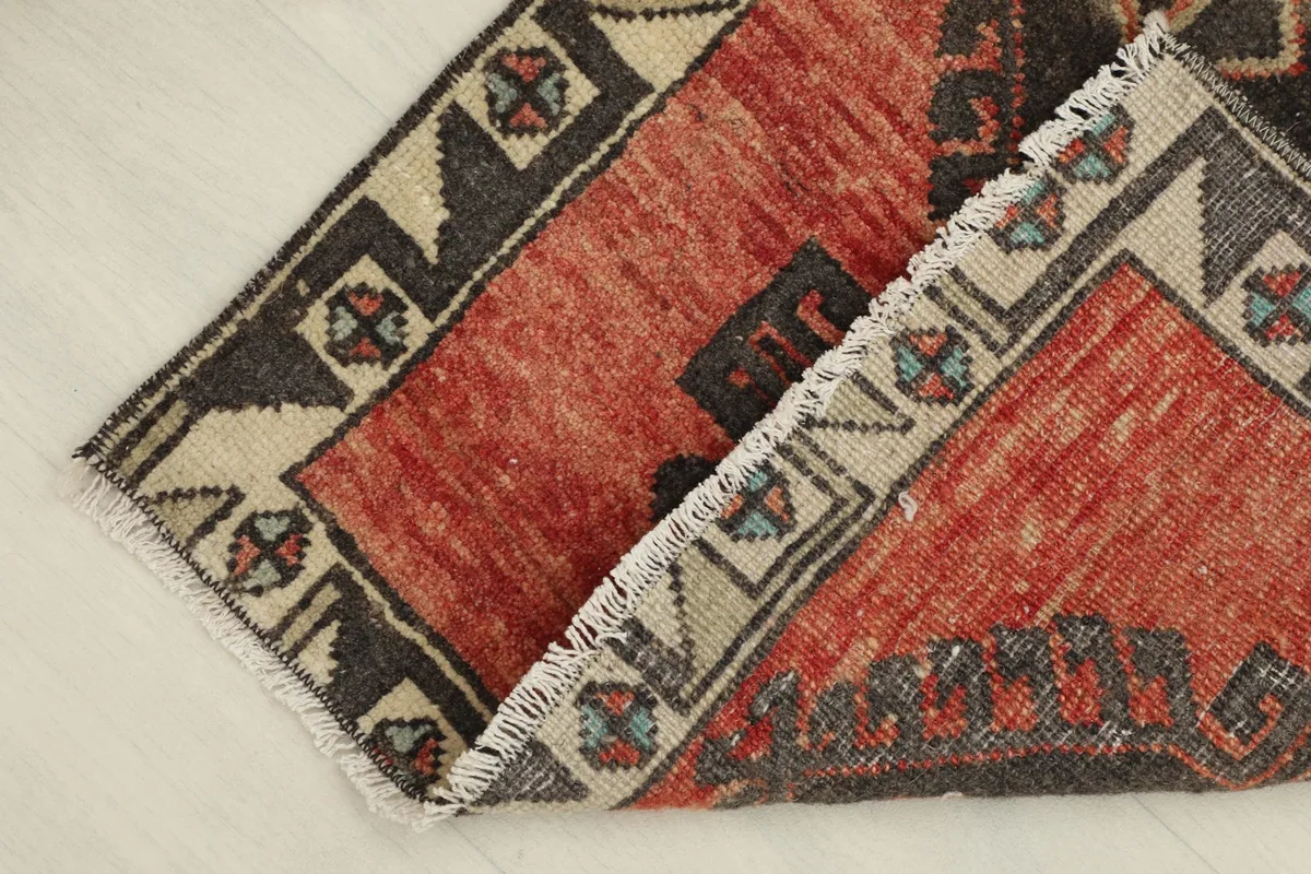 Rug folded to show the flexibility and thickness of the vintage wool pile