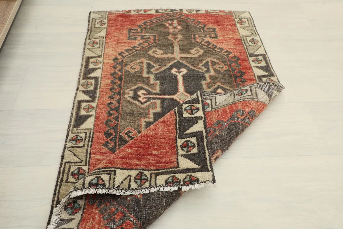 Another folded view, revealing the back of the rug and the reverse side of the pattern
