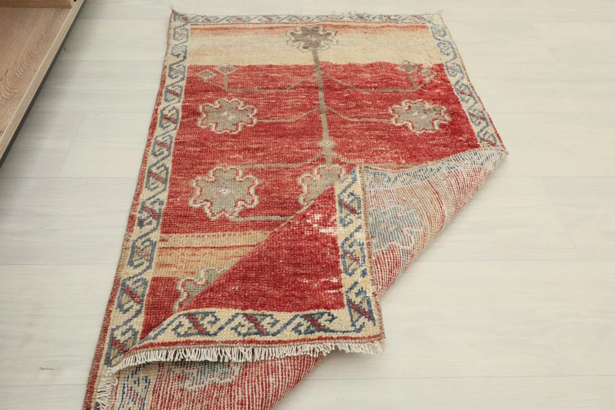 The rug folded to show its flexibility and the texture of both the front and back surfaces.
