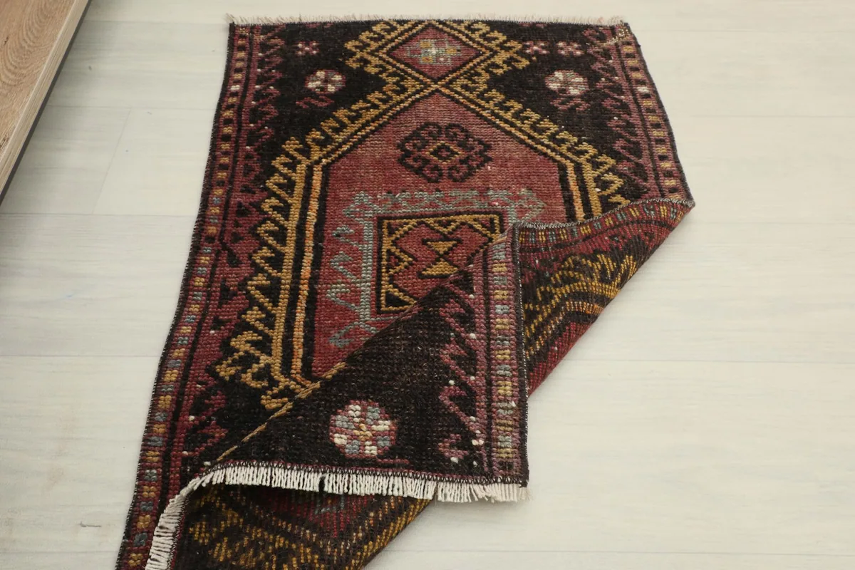 The rug partially folded, displaying the full design from an overhead perspective.