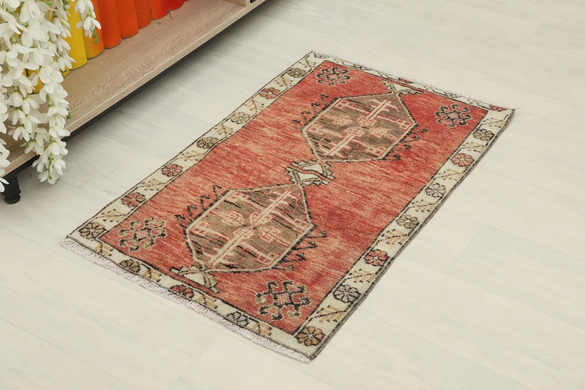 Angled view of the rust vintage Anatolian rug, showing its overall design and texture
