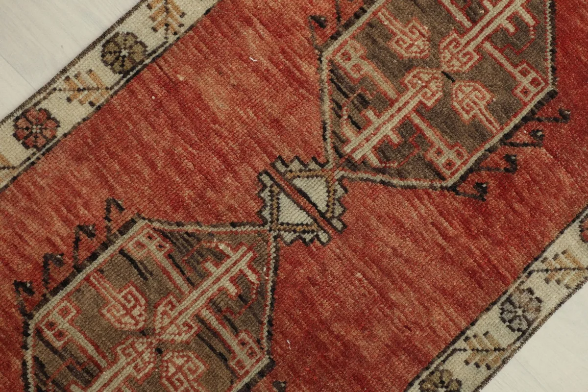 Close-up detail showing the central geometric motifs and the color variations within the rust pile