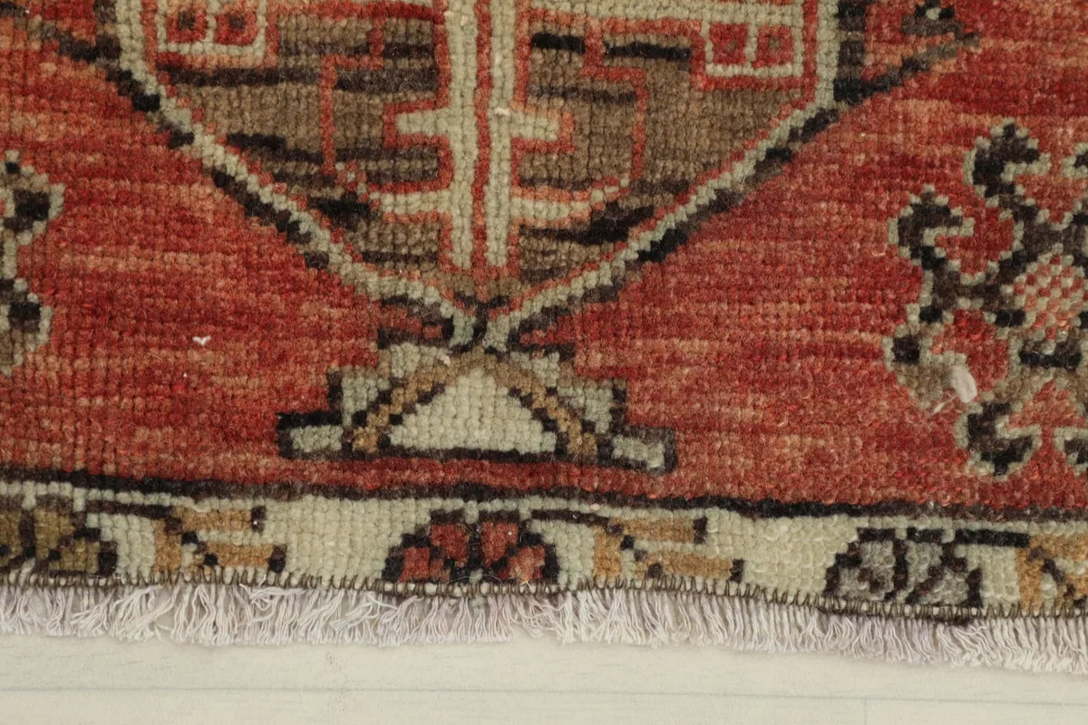 Close-up of the low wool pile and fringe on the edge of the vintage rug