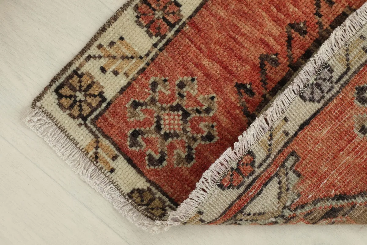 Rug partially folded, showing the flexibility and thickness of the hand-knotted wool
