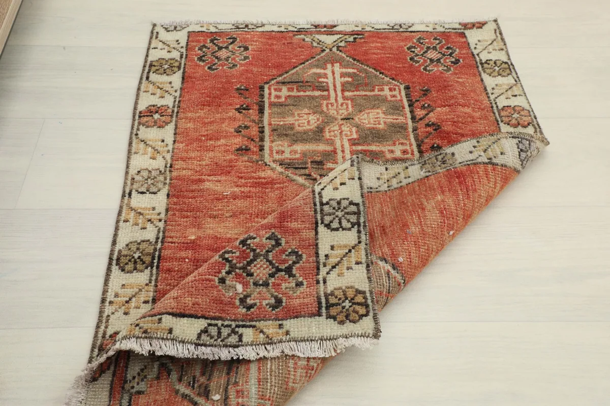 Rug folded to reveal the underside and the cotton foundation