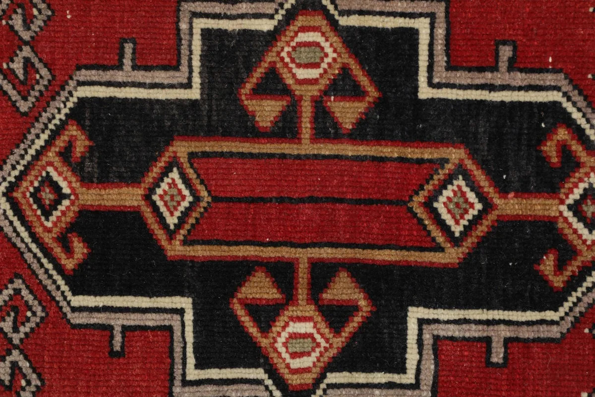 Detailed overhead view of the intricate geometric patterns in the rug's center.