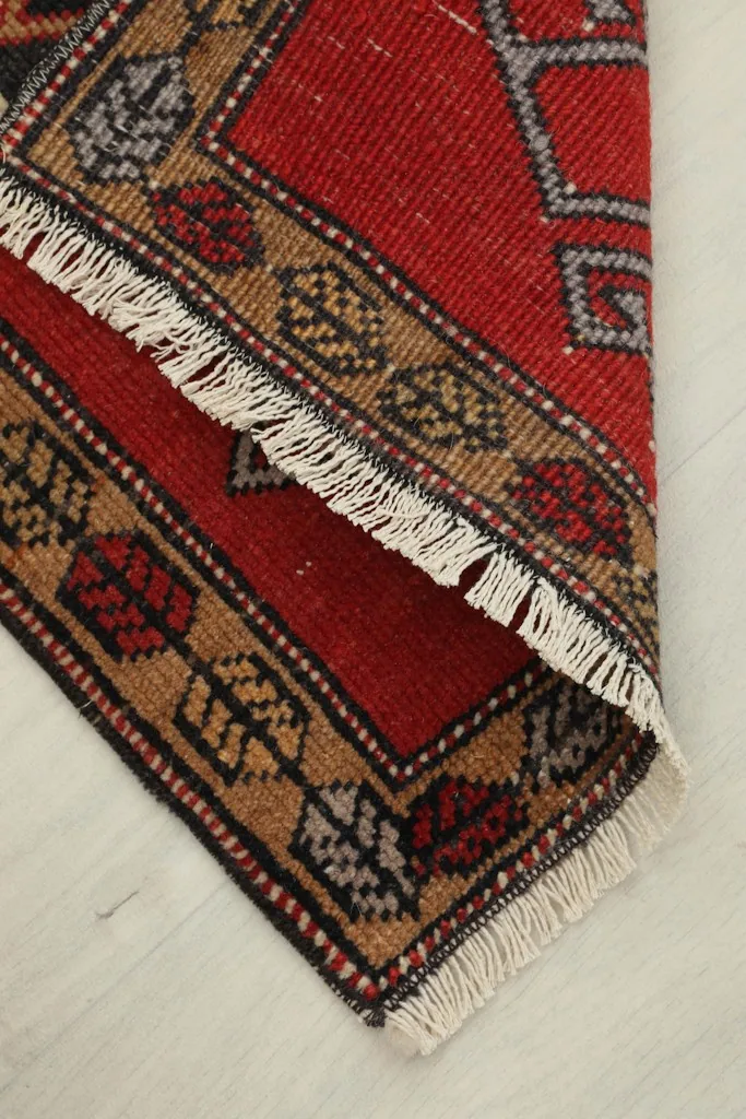 The rug folded to show its flexibility and the reverse side of the pile.
