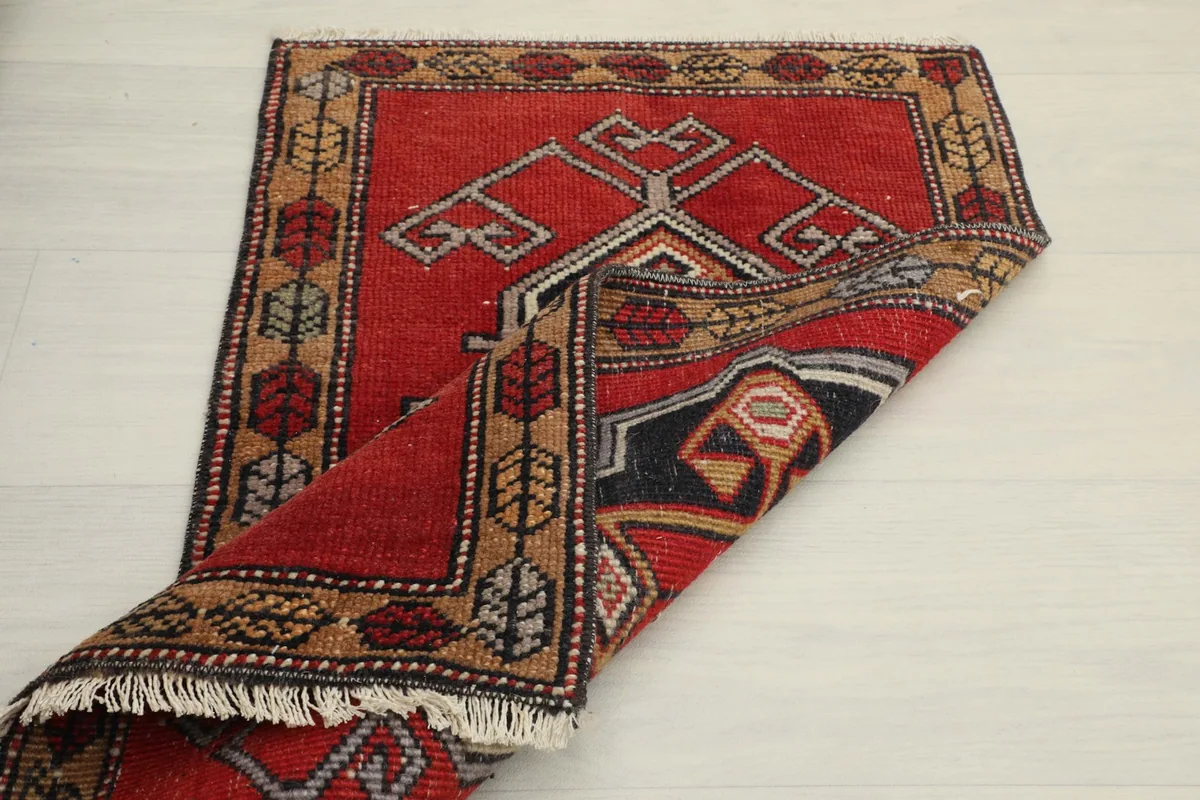 Partial fold of the rug, illustrating its thickness and hand-knotted construction.