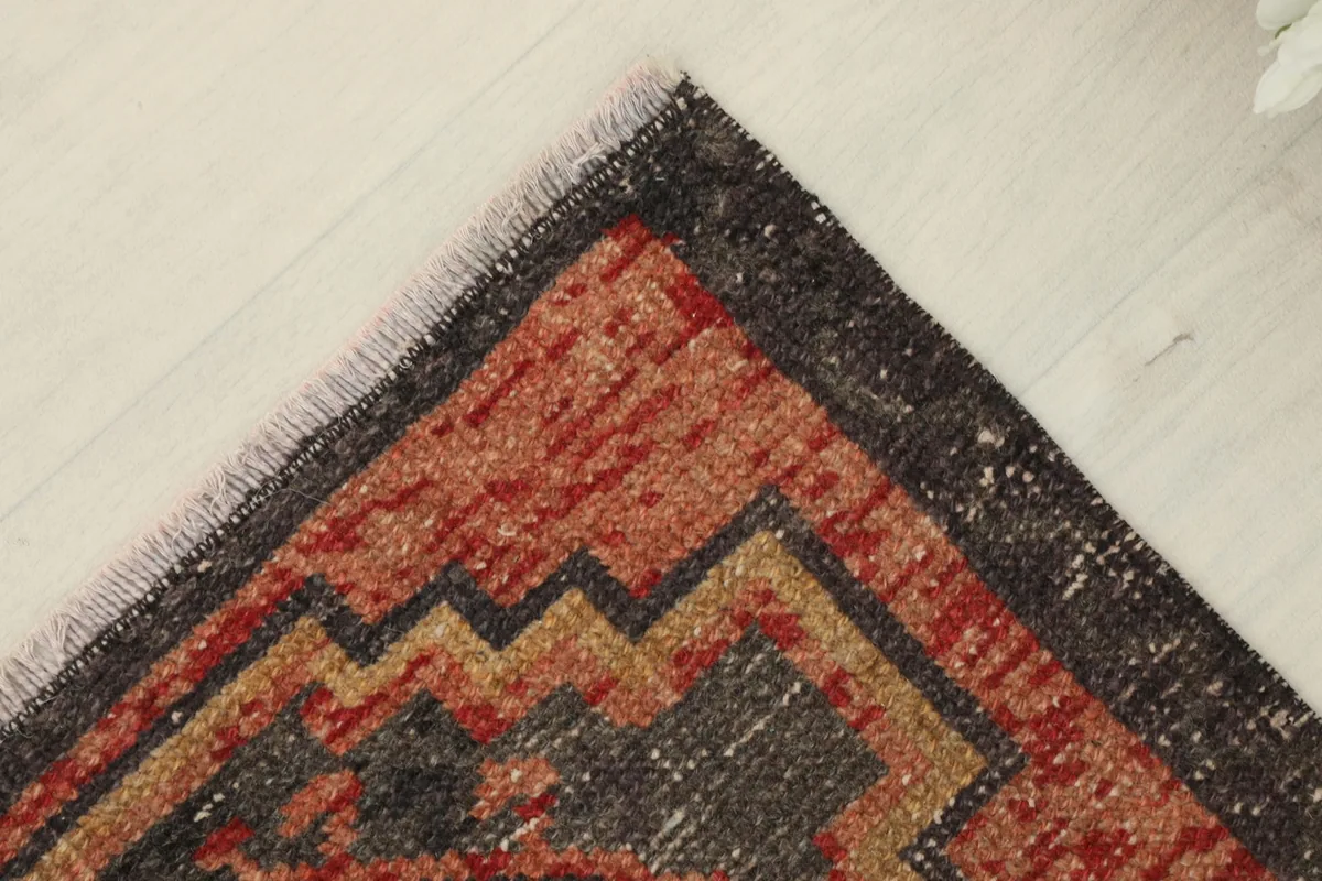 Another corner detail showing the faded charcoal border and slight wear on the edges