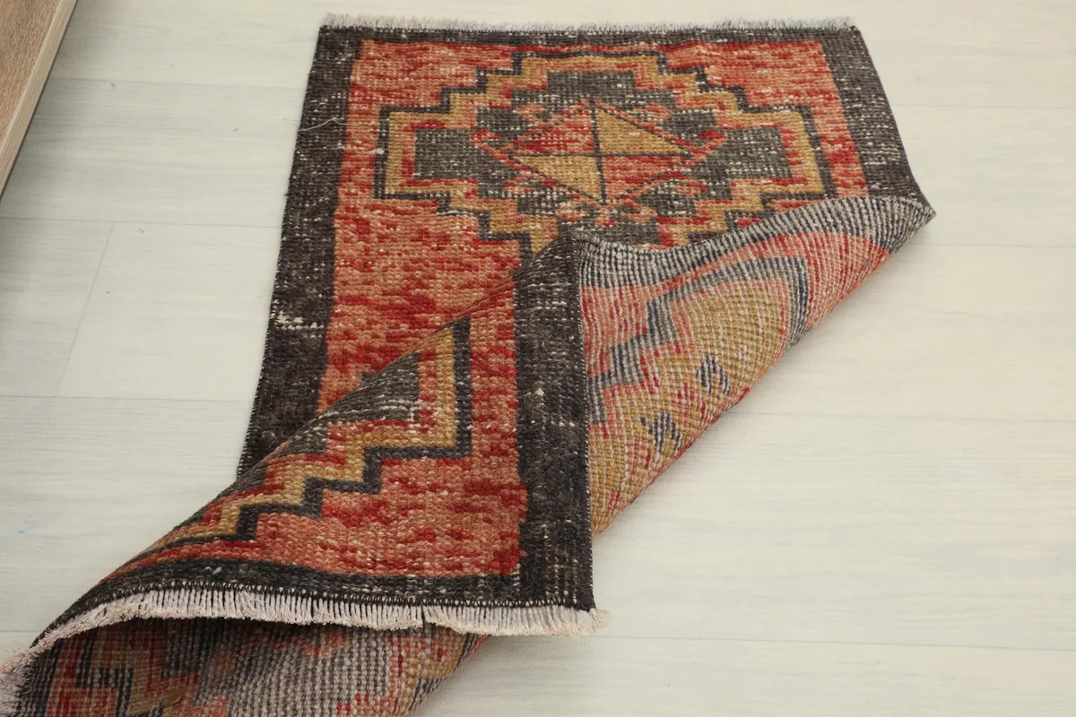Rug folded to reveal the backside, showing the cotton foundation and hand-knotted construction