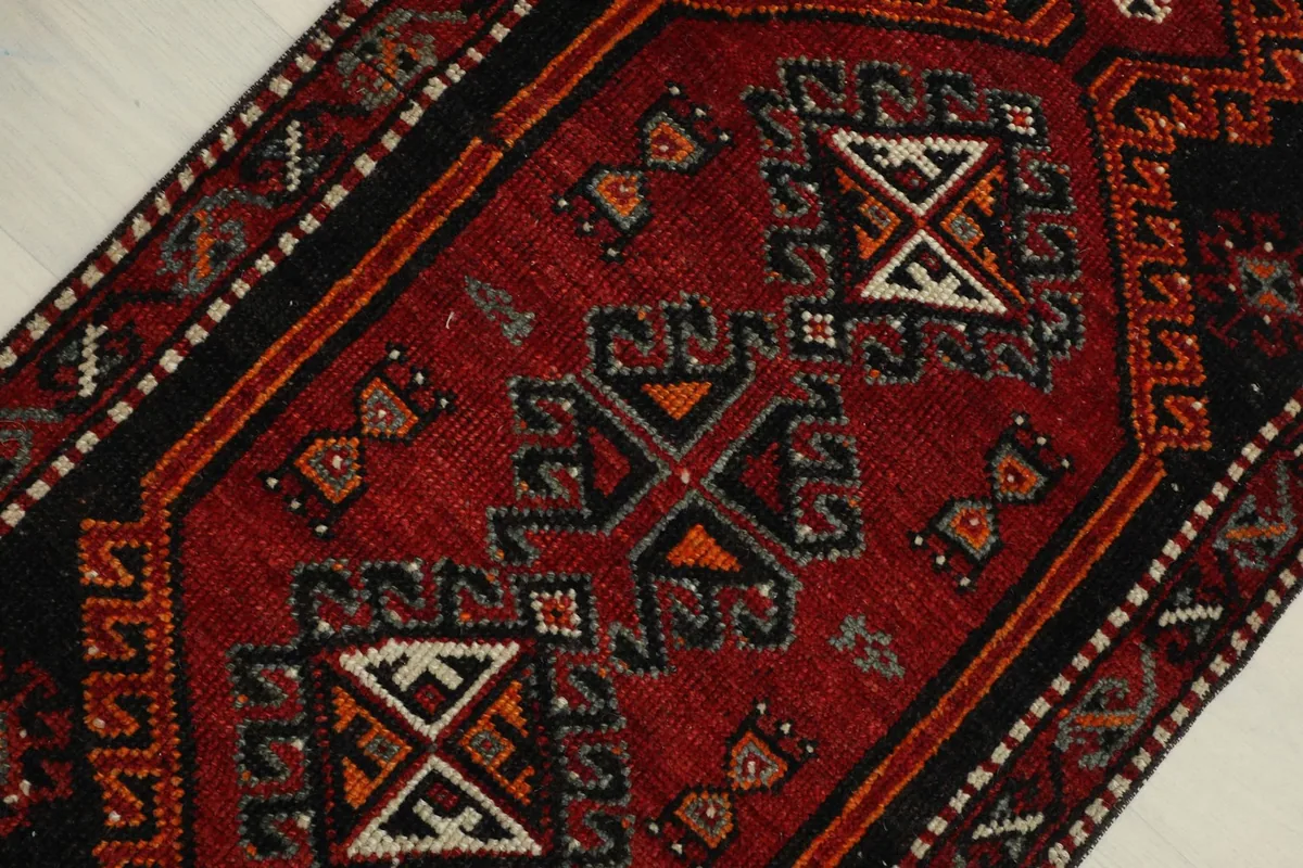 Overhead view showing the central red field and black geometric patterns