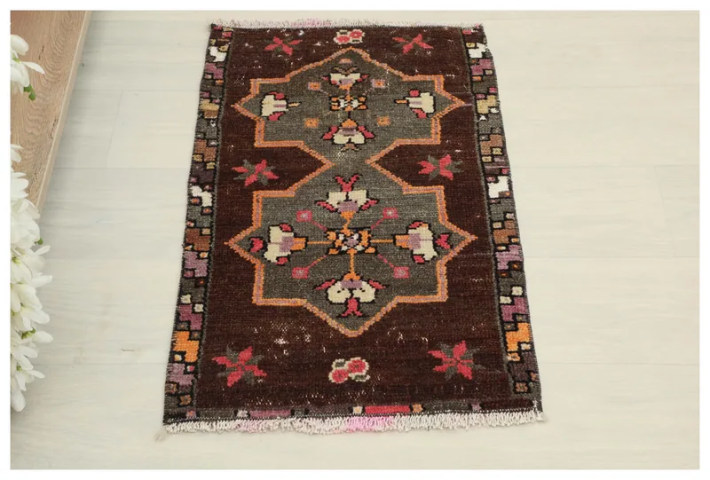 Full top view of the 1'5" x 2'5" brown and gray vintage Anatolian rug on a white background.