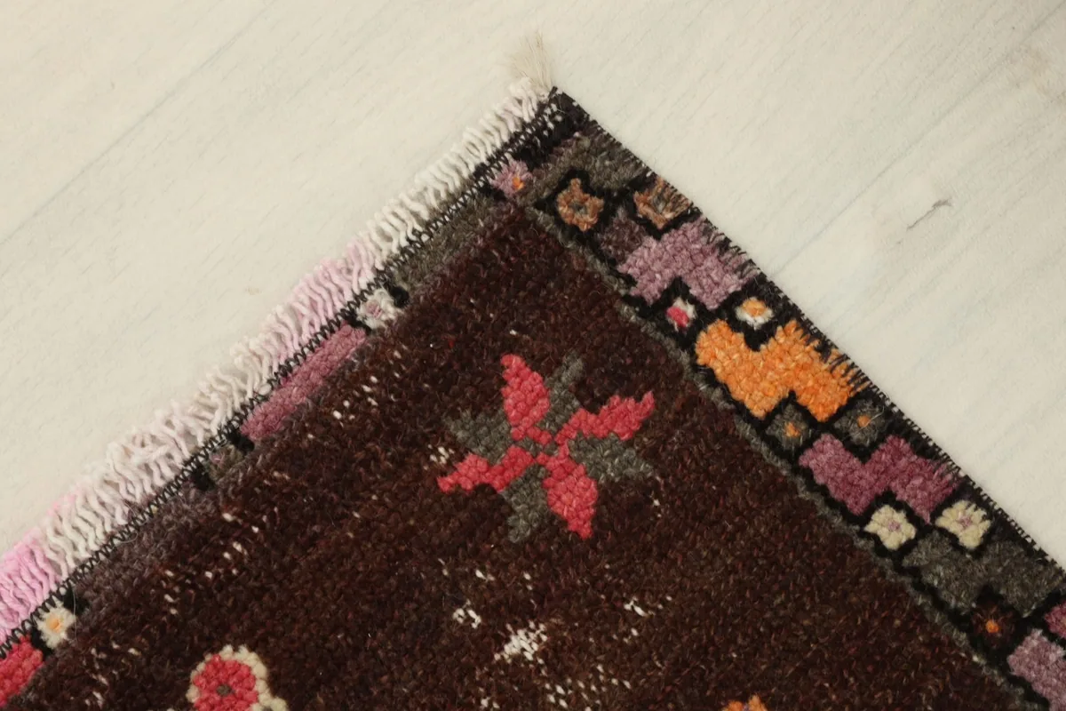 Angled detail of a corner, revealing the hand-knotted texture and the rug's rich color variations.