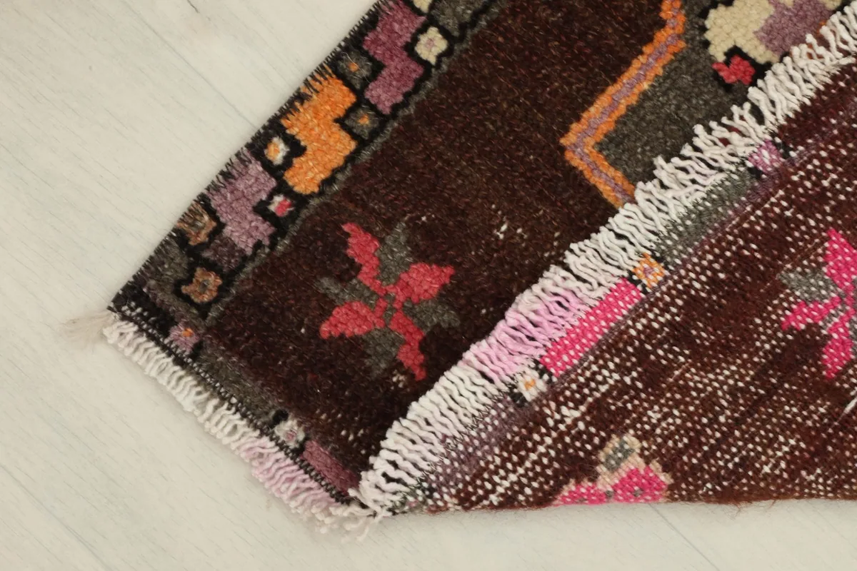 The rug folded to show the thickness of the wool pile and the construction from the side.