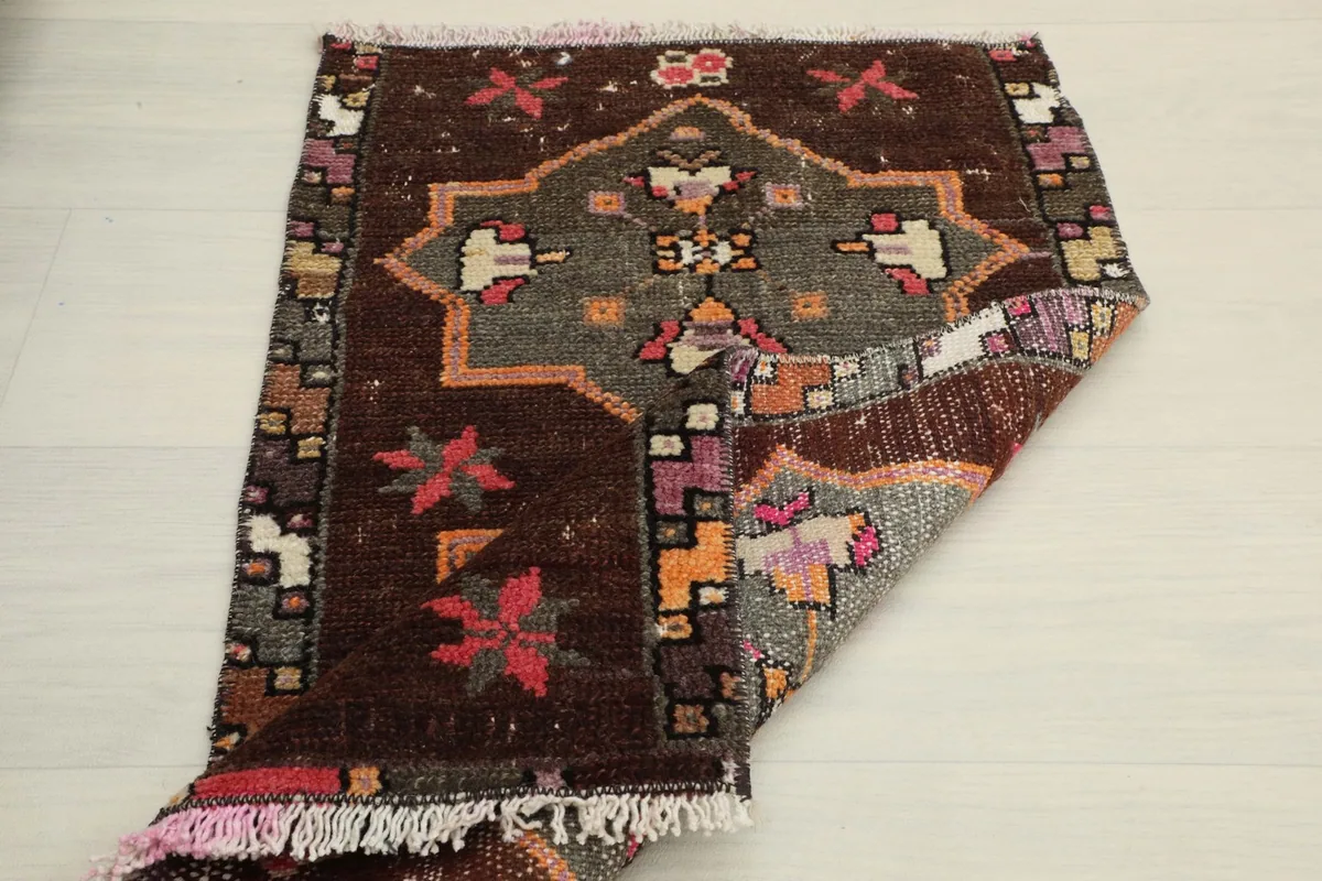 The rug partially folded, showcasing the reverse side's texture and overall design.