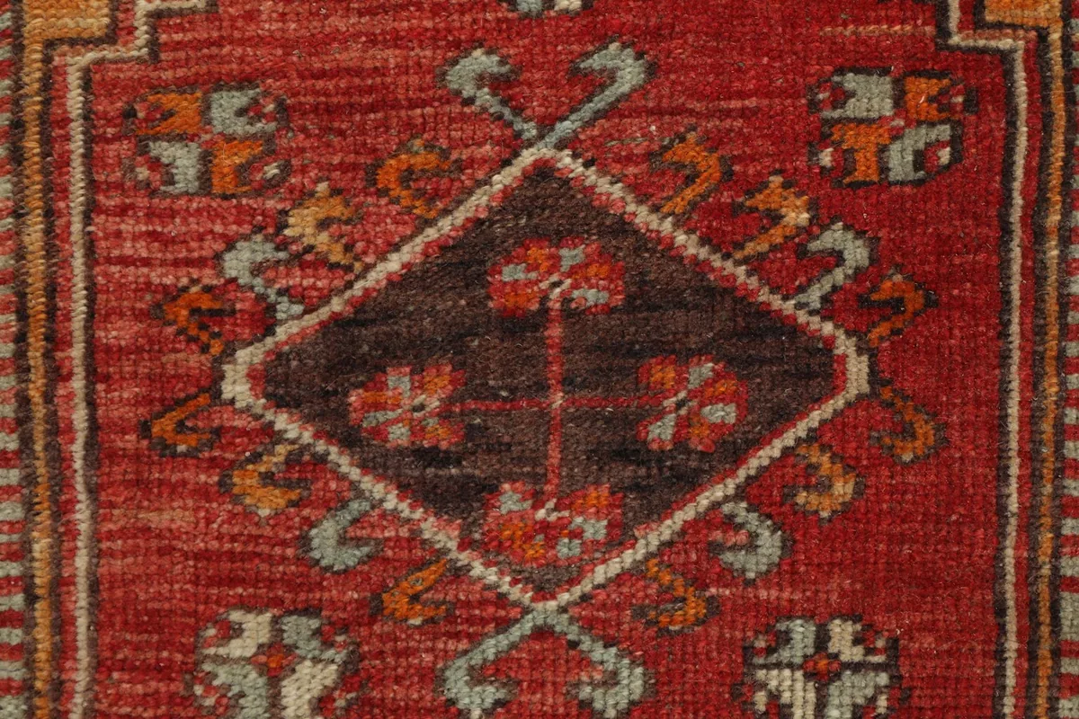 Detailed view of the central brown and red geometric motif and surrounding patterns