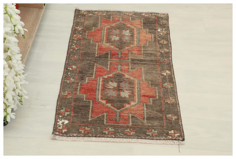 Full overhead view of the 1'6" x 3'3" brown and orange vintage Anatolian doormat on a white background.