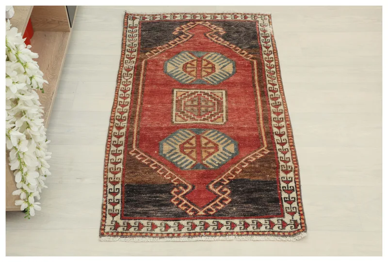 Full top view of the 2x4 red tribal geometric vintage Anatolian rug on a white background.