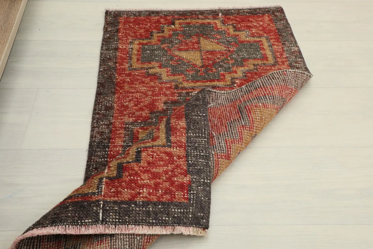The rug partially folded, illustrating its flexibility and the texture of the wool pile.