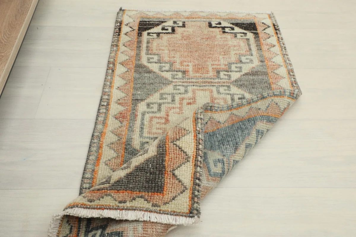 Rug partially folded, displaying the full design and flexibility of the hand-knotted construction